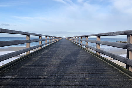 brown wooden deck above water at daytime thumbnail