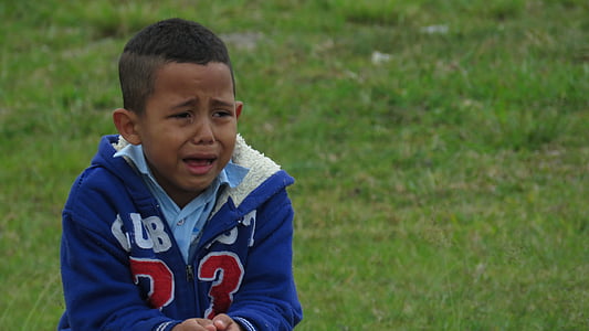 boy in blue zip-up jacket near grass field thumbnail