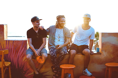 three men sitting beside each other thumbnail