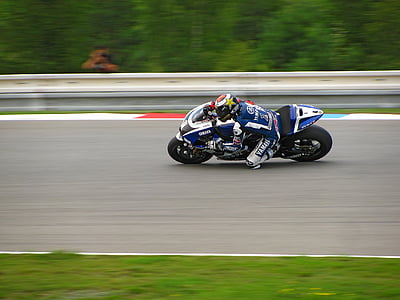 photo of man riding on a sports bike during race thumbnail