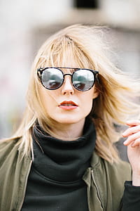 selective photography of woman wearing black turtleneck sweatshirt and round black lens sunglasses thumbnail