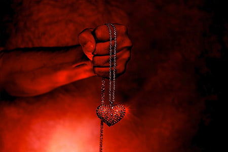person holding red heart pendant necklace thumbnail