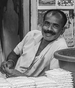 smiling man wearing shirt in grayscale photography thumbnail