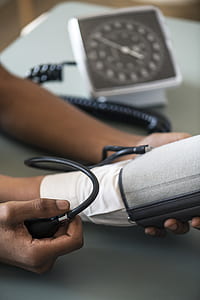person using spygmomanometer on person's hand thumbnail
