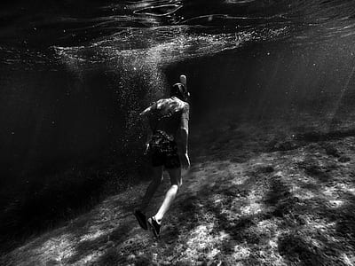 grayscale photography of person diving thumbnail