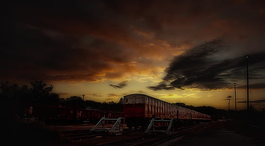 Red and White Train Taken during Sunset thumbnail