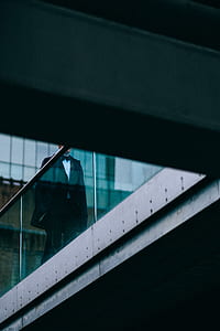 man walking on dock wearing formal suit thumbnail