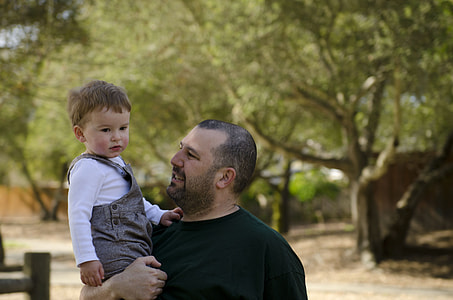 man carrying baby on shoulder thumbnail