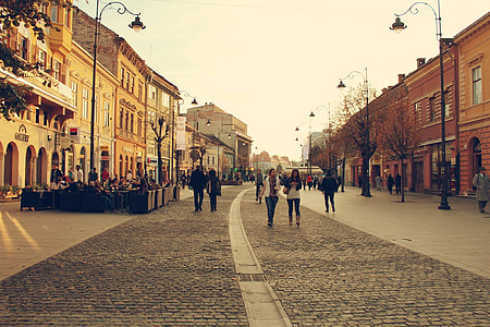 people walking between building during daytime thumbnail
