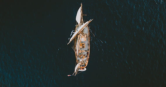 aerial photography of brown and white sailboat thumbnail