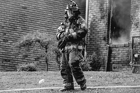 grayscale photo of man wearing fireman suit thumbnail