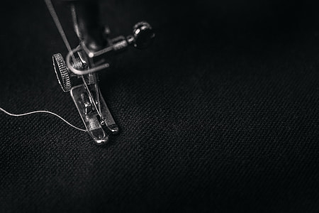 closeup photo of sewing machine sewing black textile thumbnail