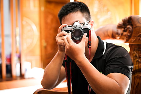 man taking photo using black and silver DSLR camera thumbnail