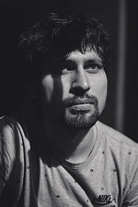 man in crew-neck T-shirt in grayscale photography thumbnail
