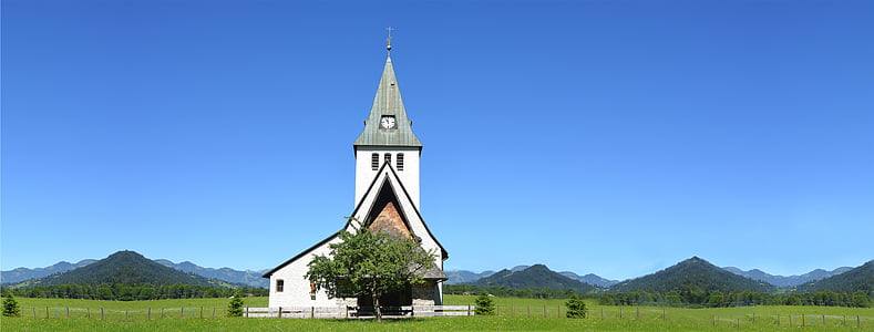 white and gray house surrounded by green grass filed near mountain under blue sky at daytime thumbnail