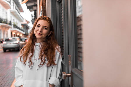 Woman Leaning on Gray Door thumbnail
