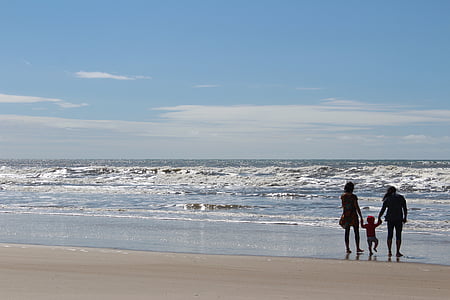 silhouette of three persons near body of water thumbnail
