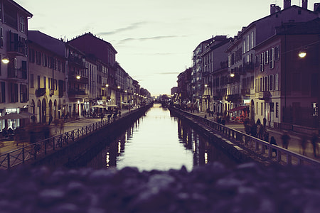 people walking beside canal and residential houses thumbnail