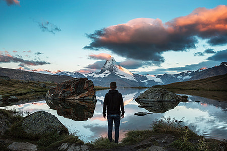 Person Looking at Beautiful lake and mountains landscape in Switzerland thumbnail