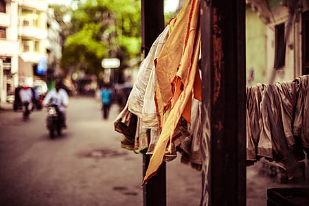 brown quilt hanged between two posts thumbnail