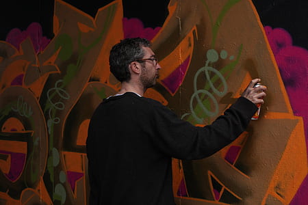 person holding paint spray can thumbnail
