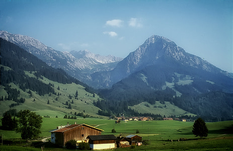 wooden houses near mountain under blue sky at daytime thumbnail