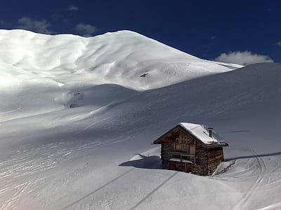 brown wooden house on snow thumbnail