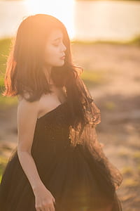 shallow focus photography of woman in black strapless dress thumbnail