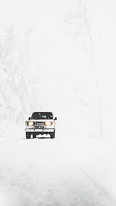white Toyota SUV on road during heavy snow weather condition at daytime thumbnail