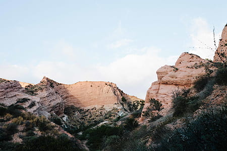 green grass field beside rock formation thumbnail