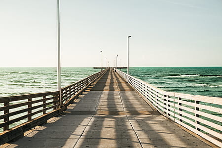 footbridge over body of water photograph thumbnail