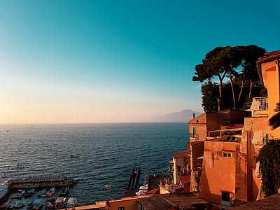 landscape photography of building near body of water during daytime thumbnail