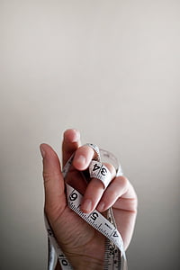 person holding white measuring tape thumbnail