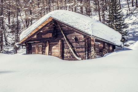 brown house covered by snow during daytime thumbnail