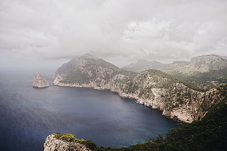 aerial view of body of water near mountains thumbnail