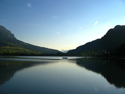 long exposure of calm body of water and mountain during daytime thumbnail