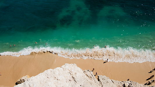 aerial photo of people on sands near shoreline thumbnail