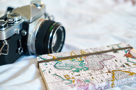 map notebook beside silver bridge camera thumbnail