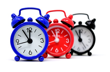 three blue, red, and black twin bell alarm clocks thumbnail
