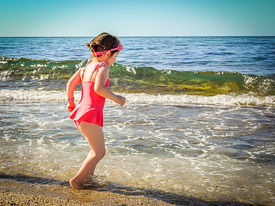 girl standing on shore during daytime thumbnail