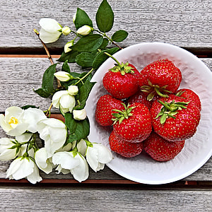 red strawberries in white ceramic bowl thumbnail