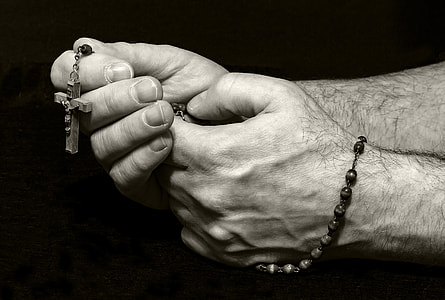 grayscale photography of person holding rosary thumbnail