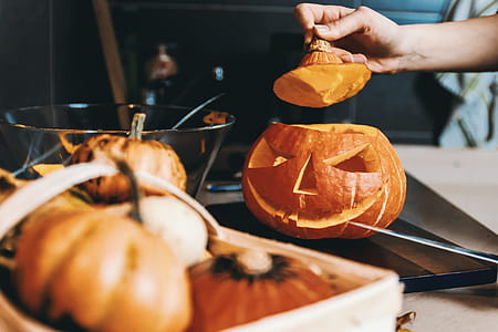Girls hands carve the pumpkin. Halloween. thumbnail