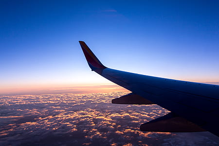 passenger plane flying above white clouds thumbnail