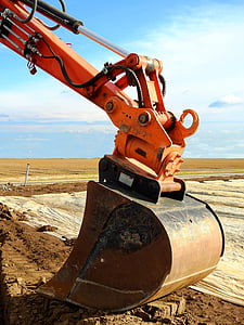 orange and brown heavy equipment under blue sky at daytime thumbnail