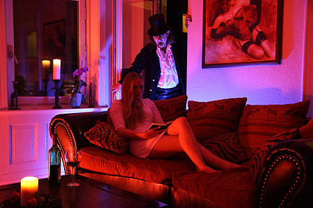woman lying on couch near magician thumbnail