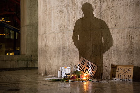 shadow of man standing in front of lighted candles with signage thumbnail