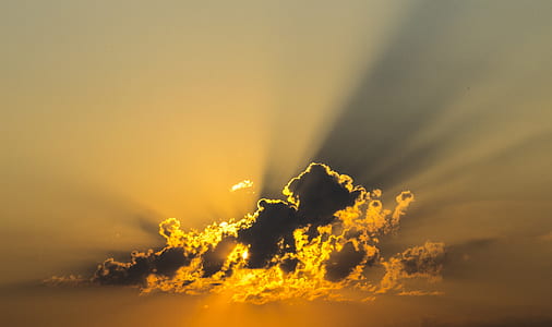 sun covered by clouds emitting sun ray thumbnail