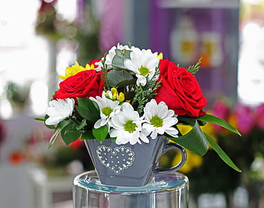 grey potted white and red flowers on glass holder thumbnail