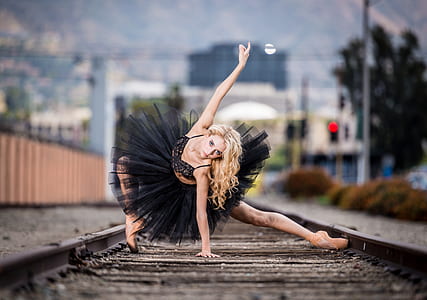 woman in black dress on railway at daytime thumbnail